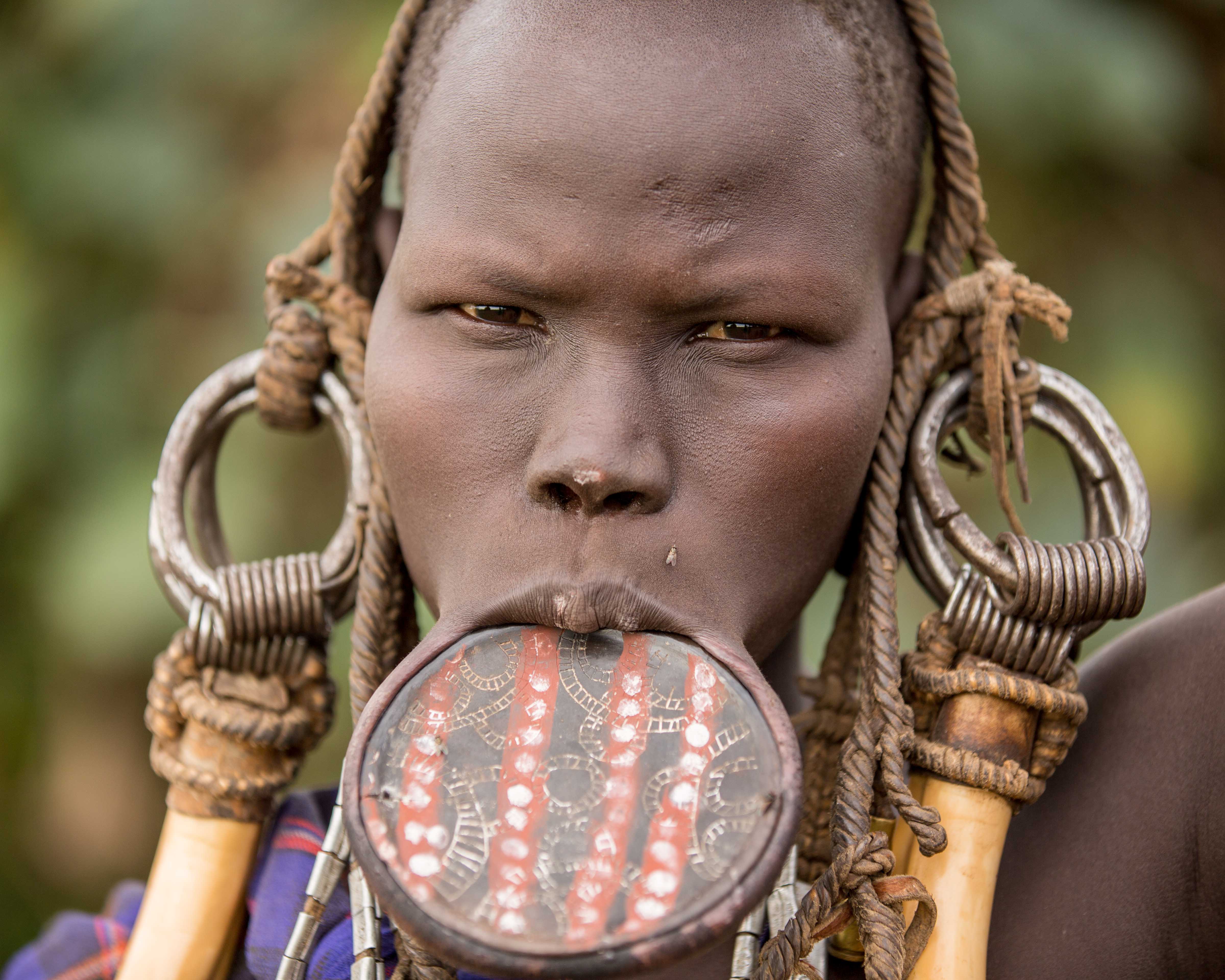 large-ear-stretchings-and-lip-plate-piercing