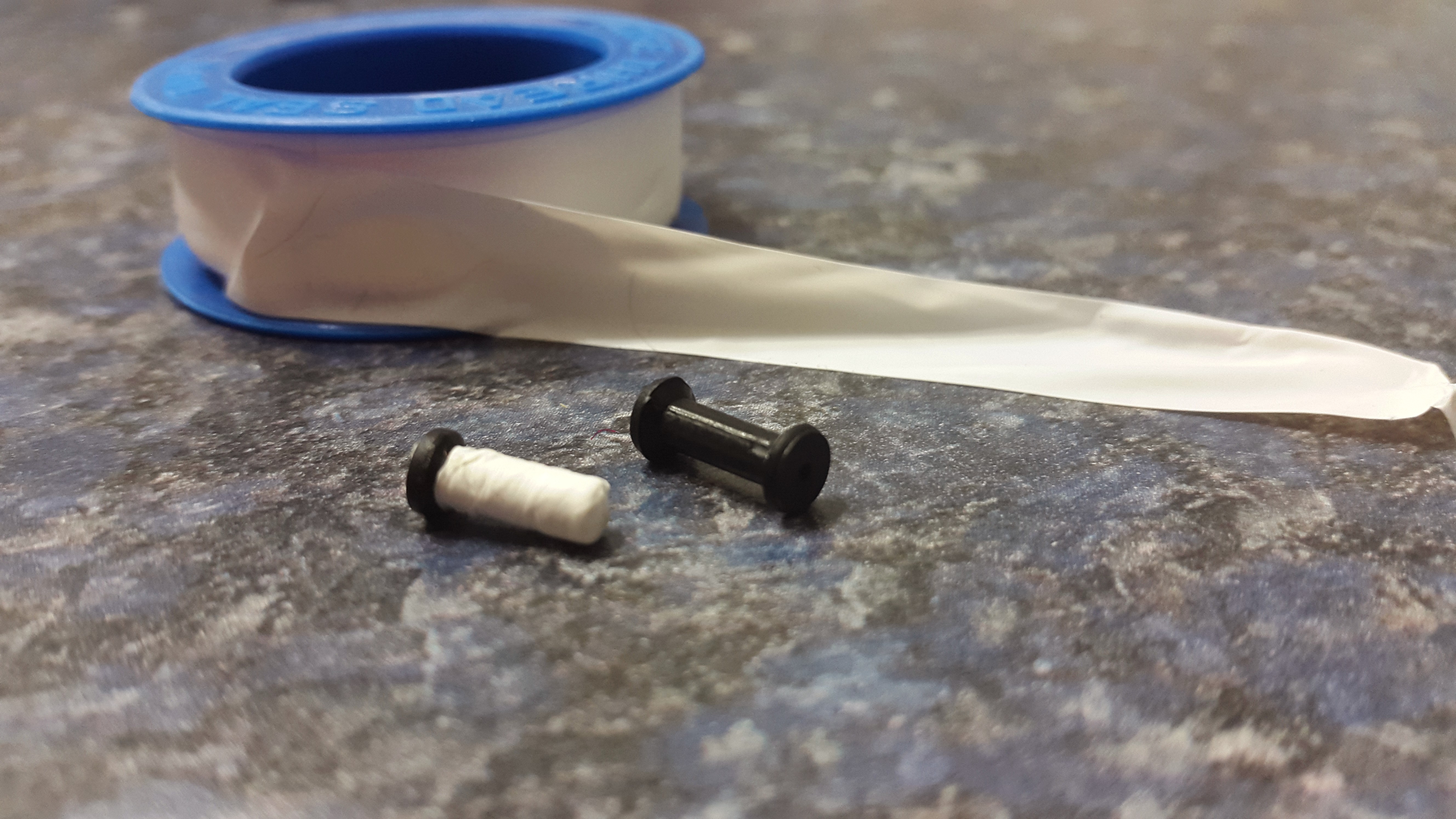 applying PTFE tape to a flesh plug